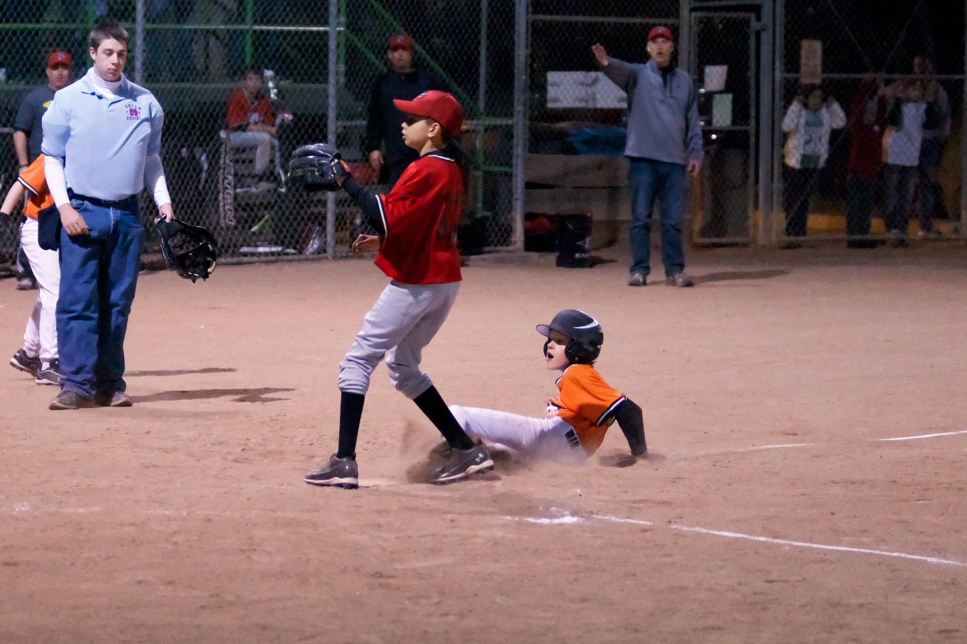 the young child tries to slide into home plate