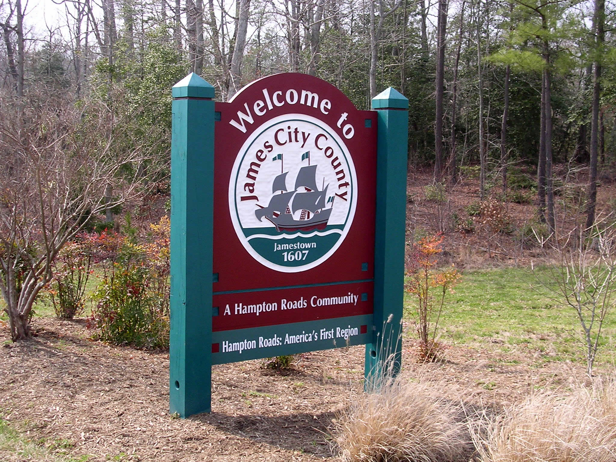 a welcome sign for a state park with a wooden sign