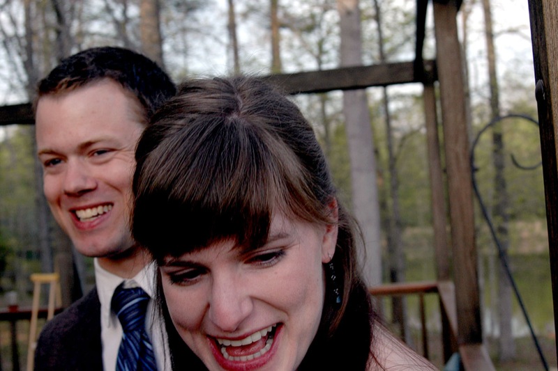 two people with dark hair smile while posing