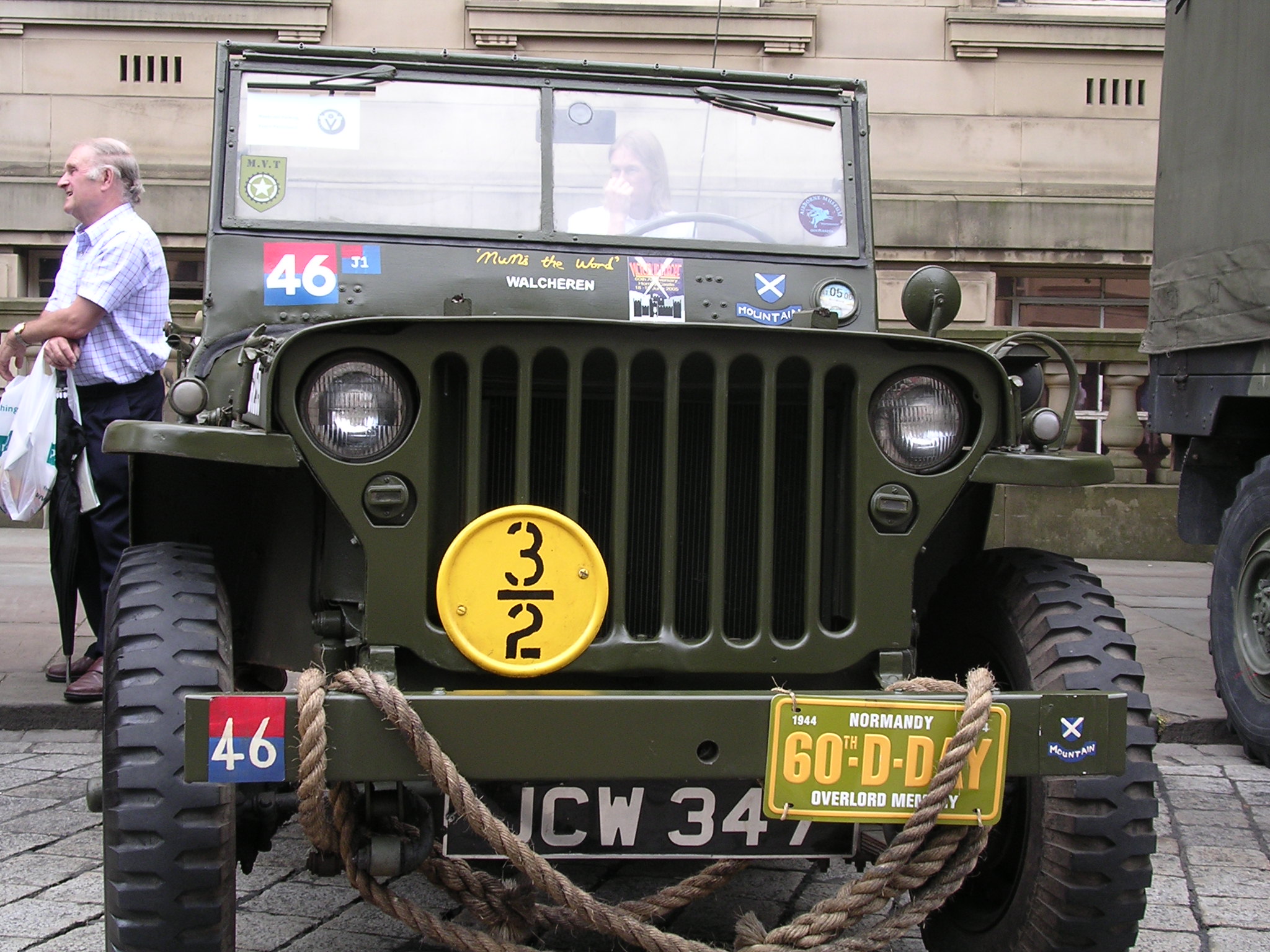 a large military jeep with its flat tires on the side