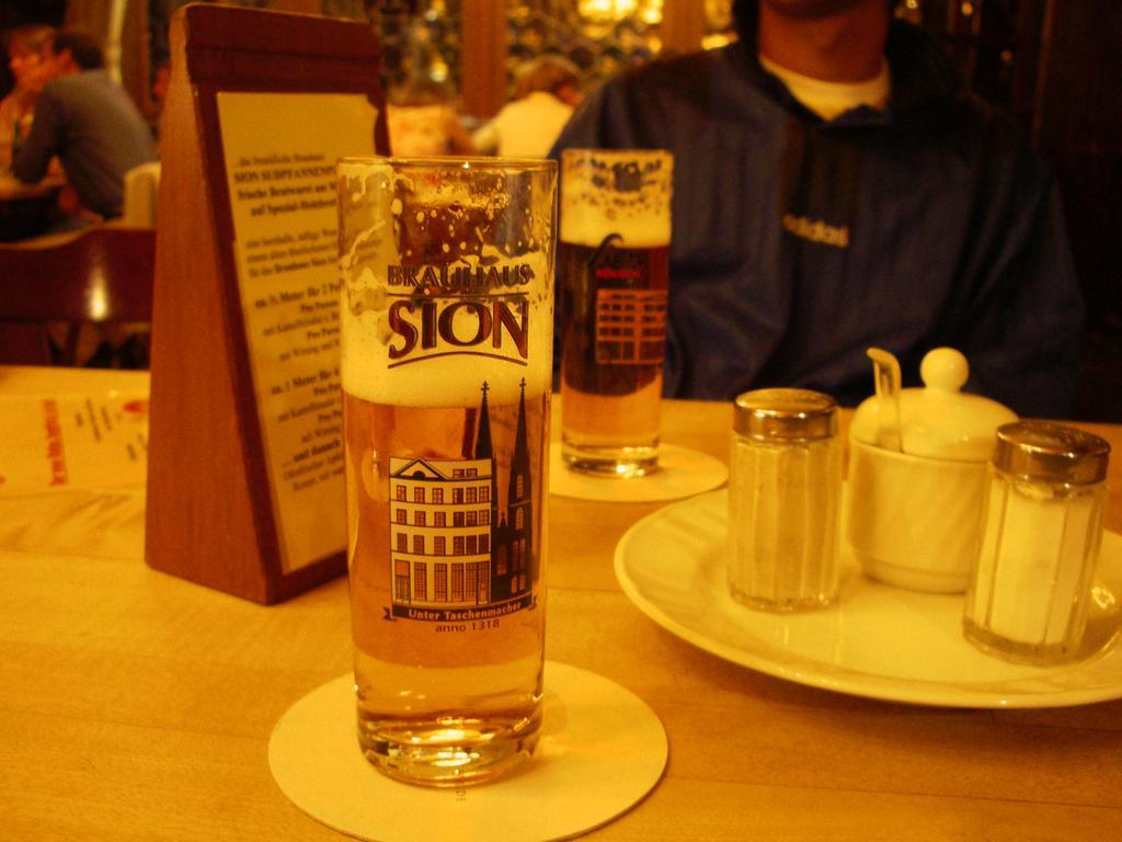 two cups with beer are on a table