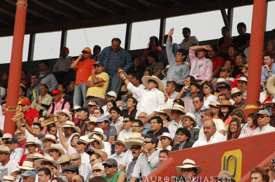 people wearing hats and one holding up his hand to the side