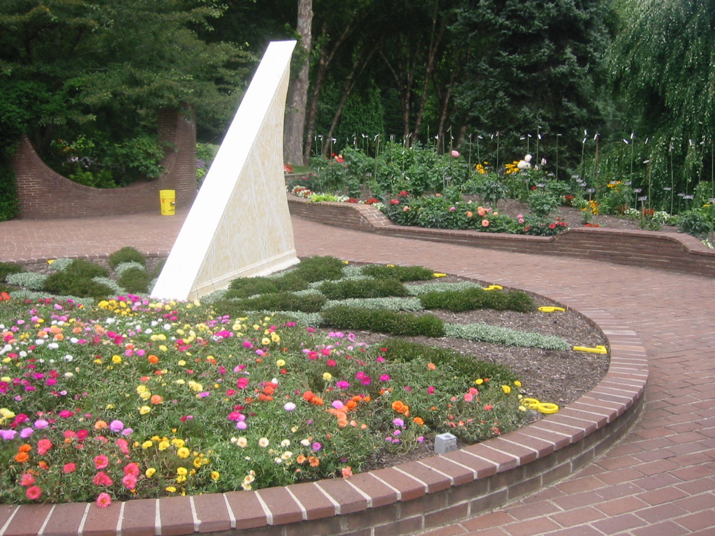 a monument is shown in a flower garden