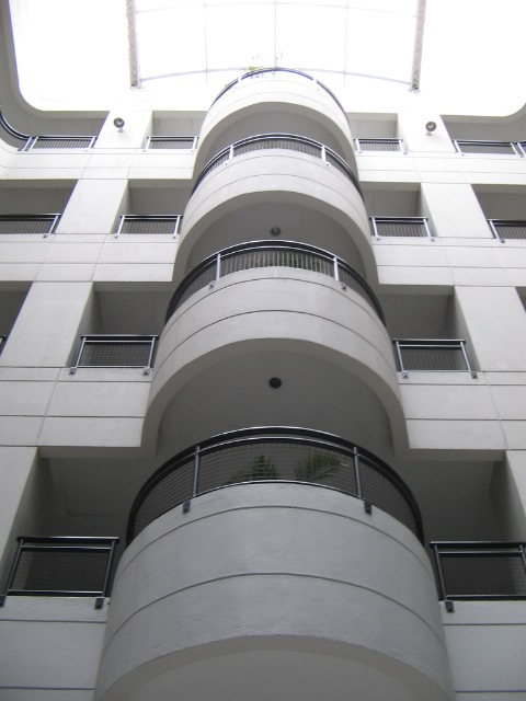 the view from underneath an elevated area with multiple balconies