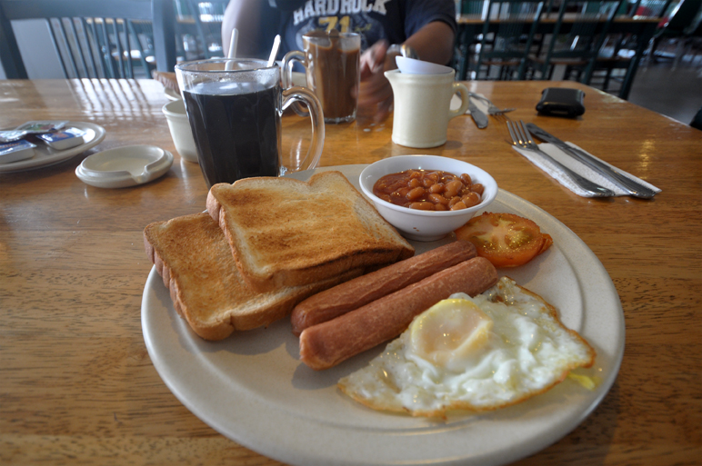 sausage, eggs and toast on a plate at a restaurant