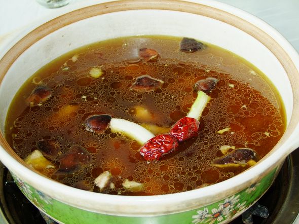 a pot of soup on top of a stove