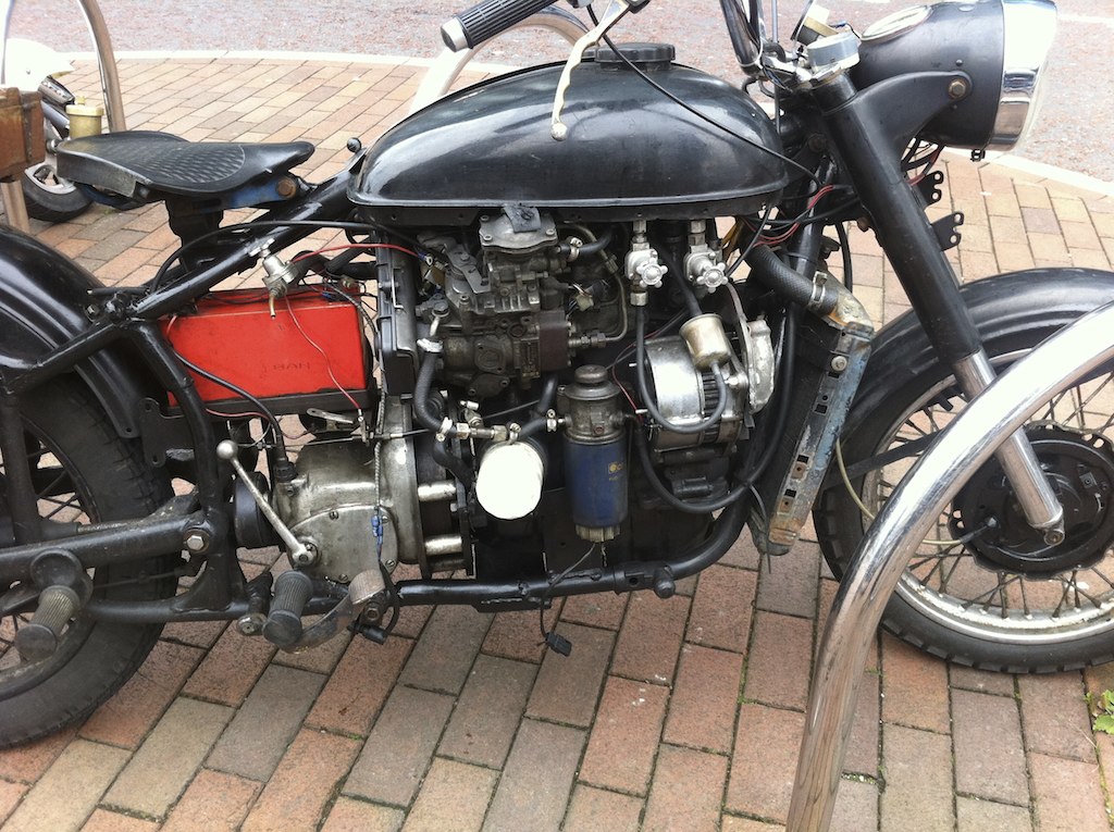 a motorcycle is parked outside on brick walkways