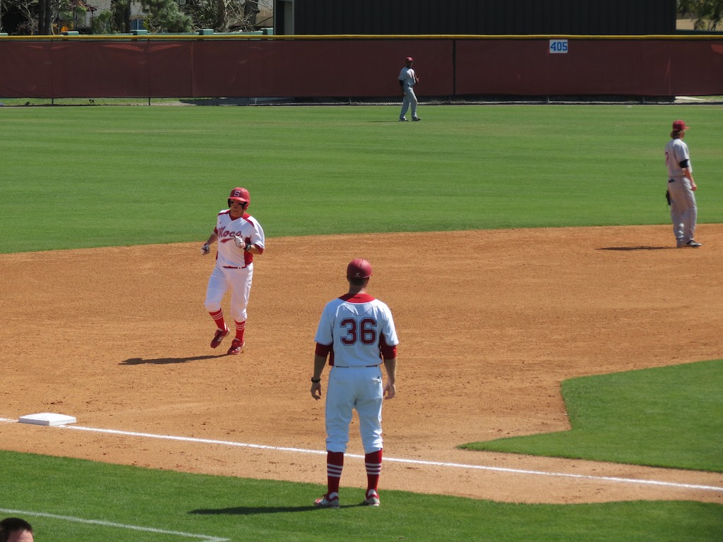 there are three male baseball players on the field