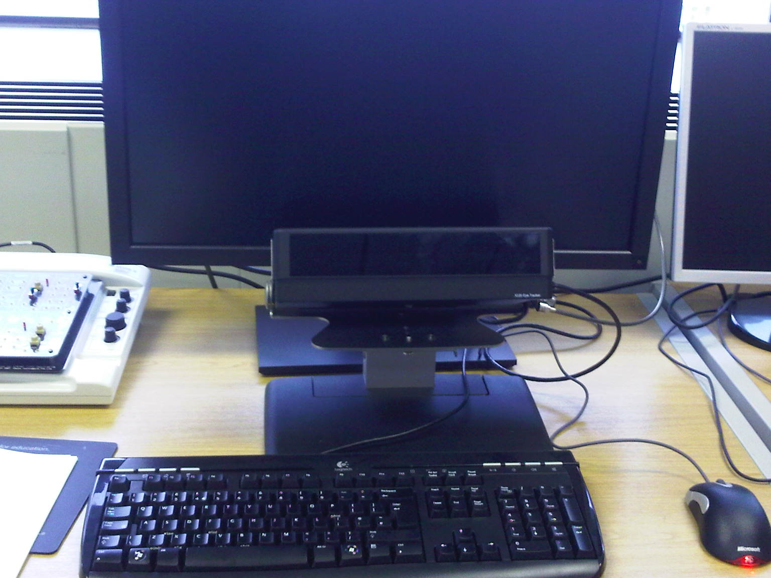 a computer with a keyboard, monitor and other electrical equipment