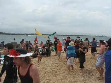 a crowd of people on the beach at a beach party