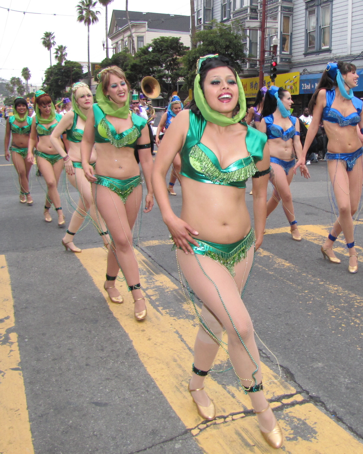 a group of woman in colorful bathing suits on a street