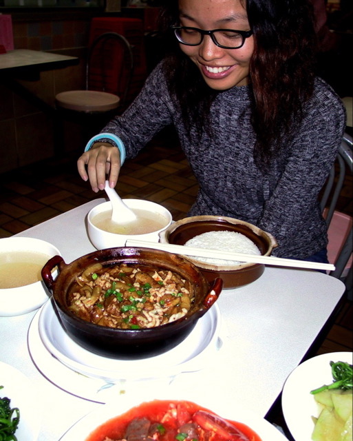 a woman at a table eating an asian meal