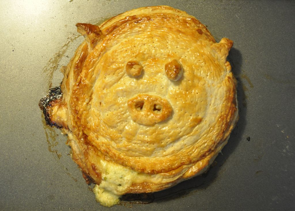 an uncooked chicken pie looks like the pig face