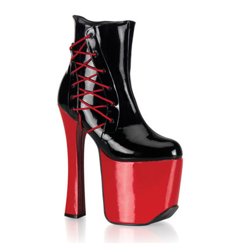 a womans high heeled boot with a red and black platform