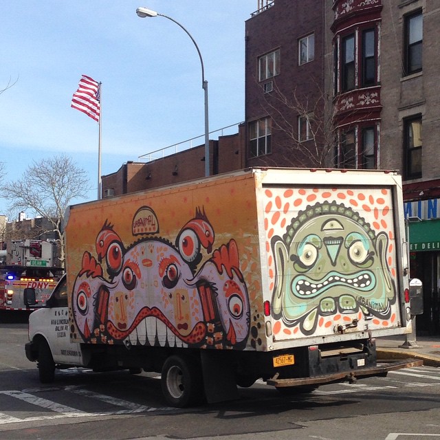 a colorful box truck has some weird drawings on it