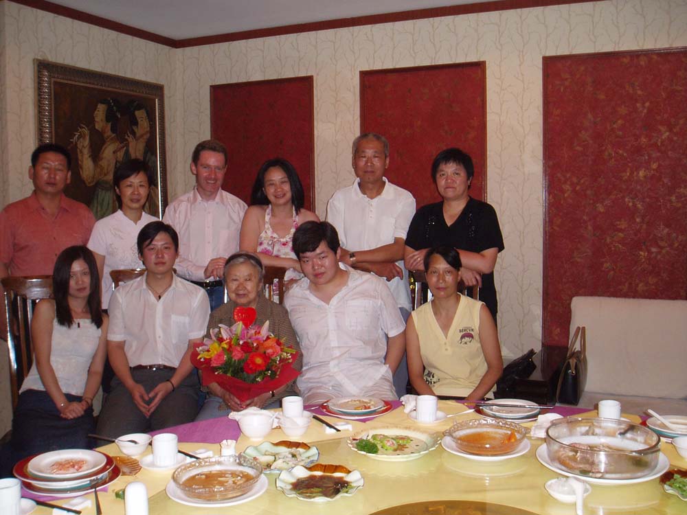 a group of people standing together at a dinner table