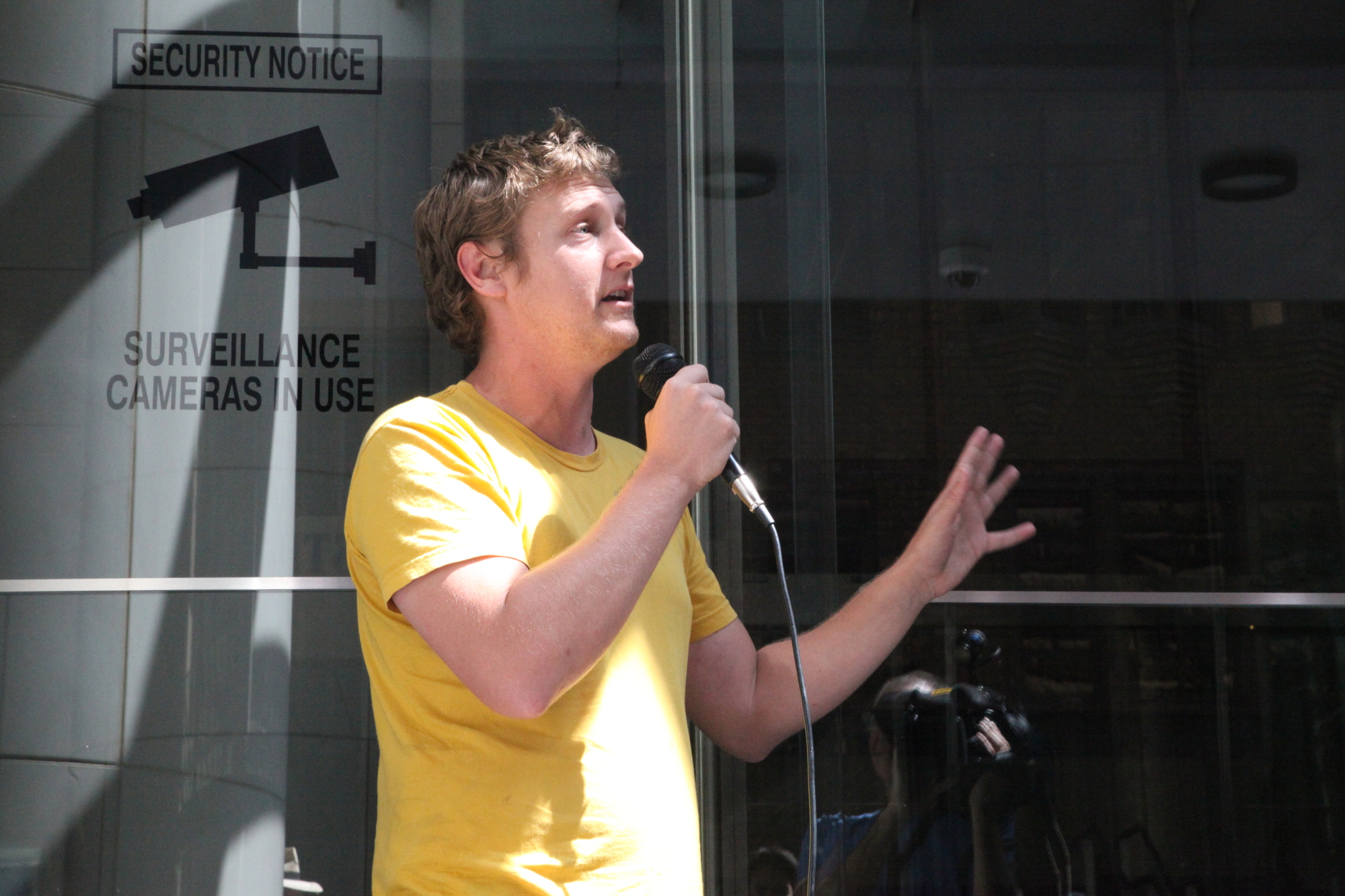 a young man is using a microphone to talk into a mic