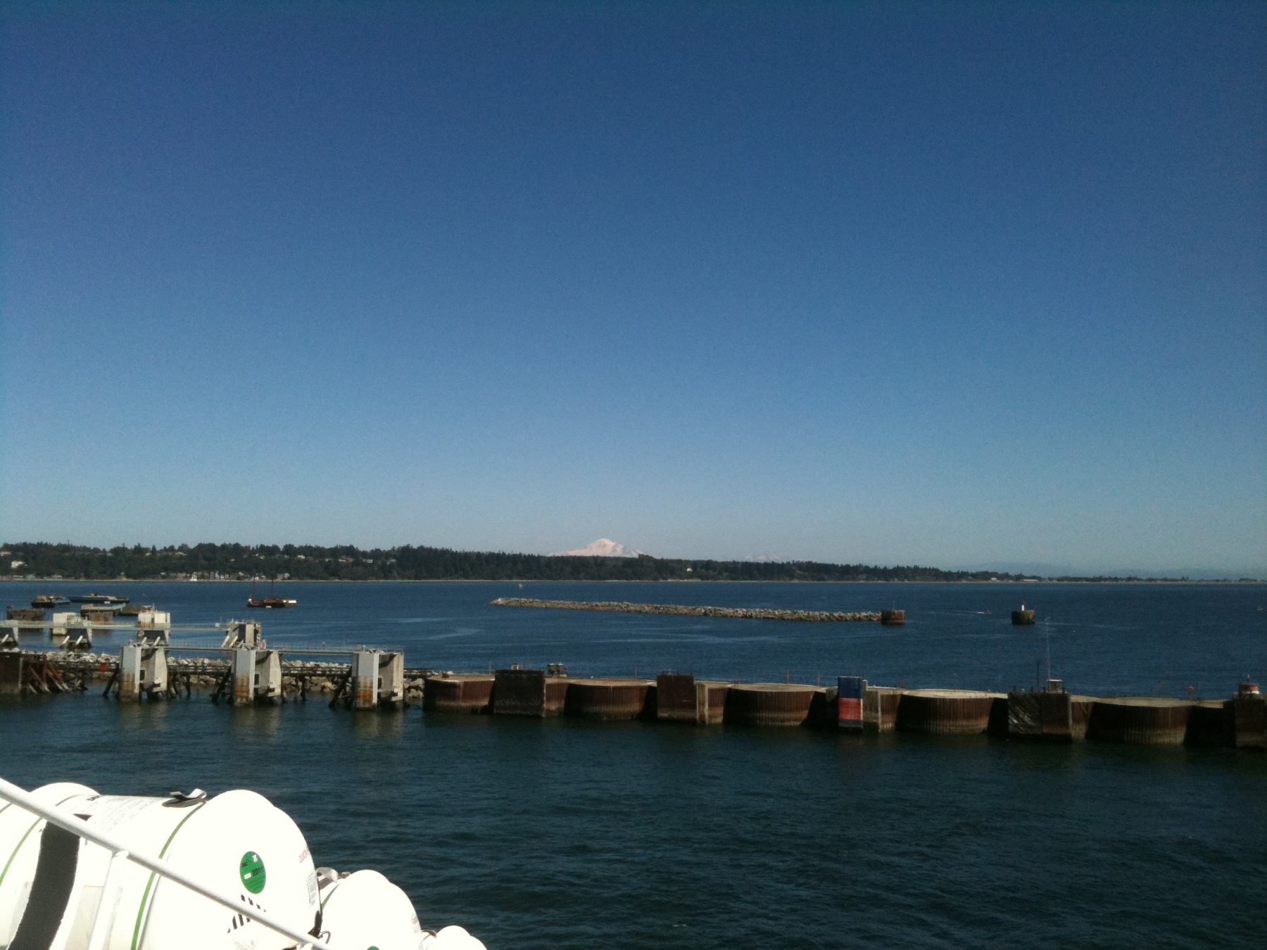 the sky is blue and there are some boats docked