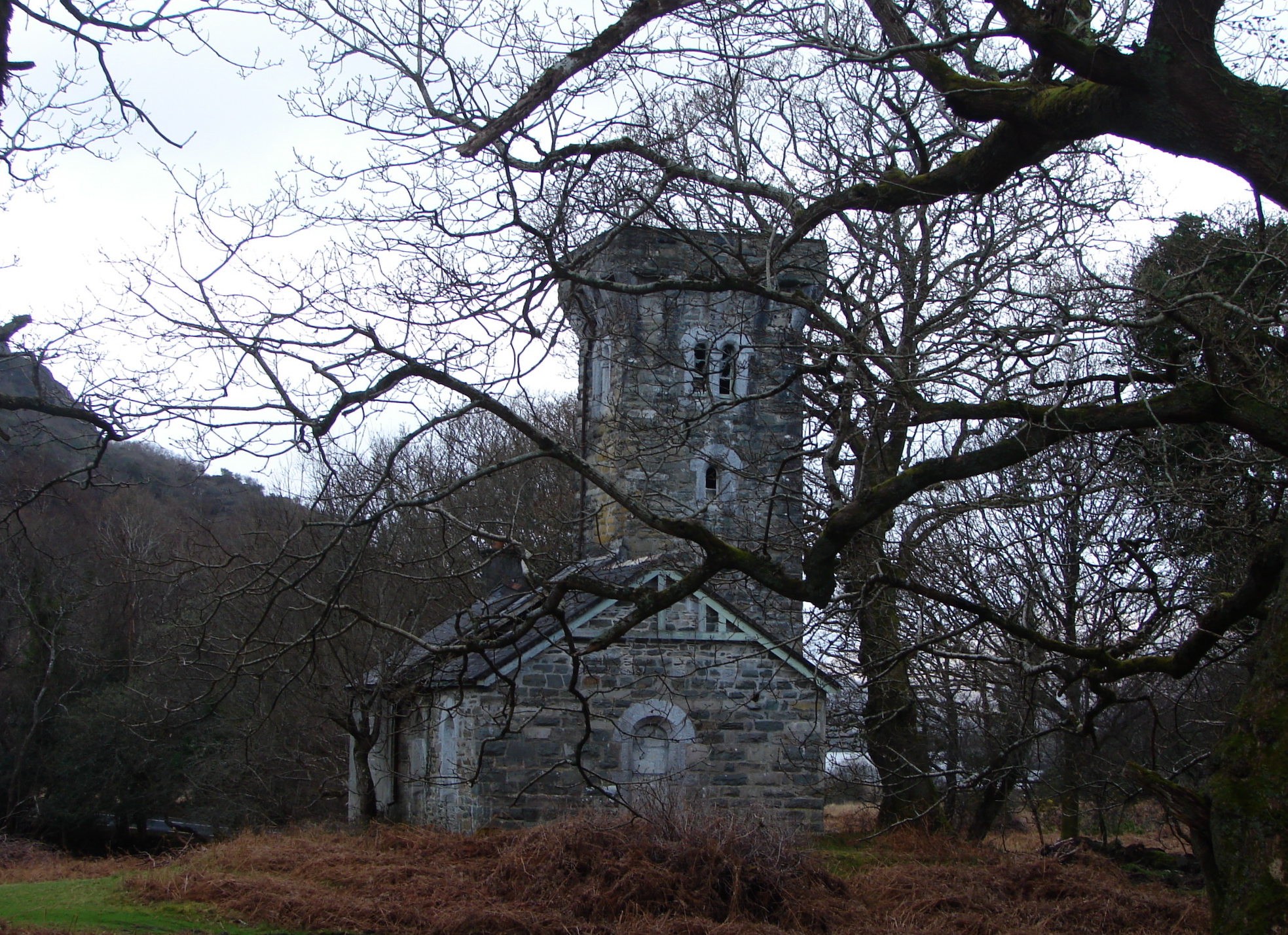 an old, brick church is surrounded by bare trees