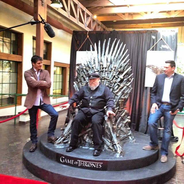 people standing around a giant iron throne