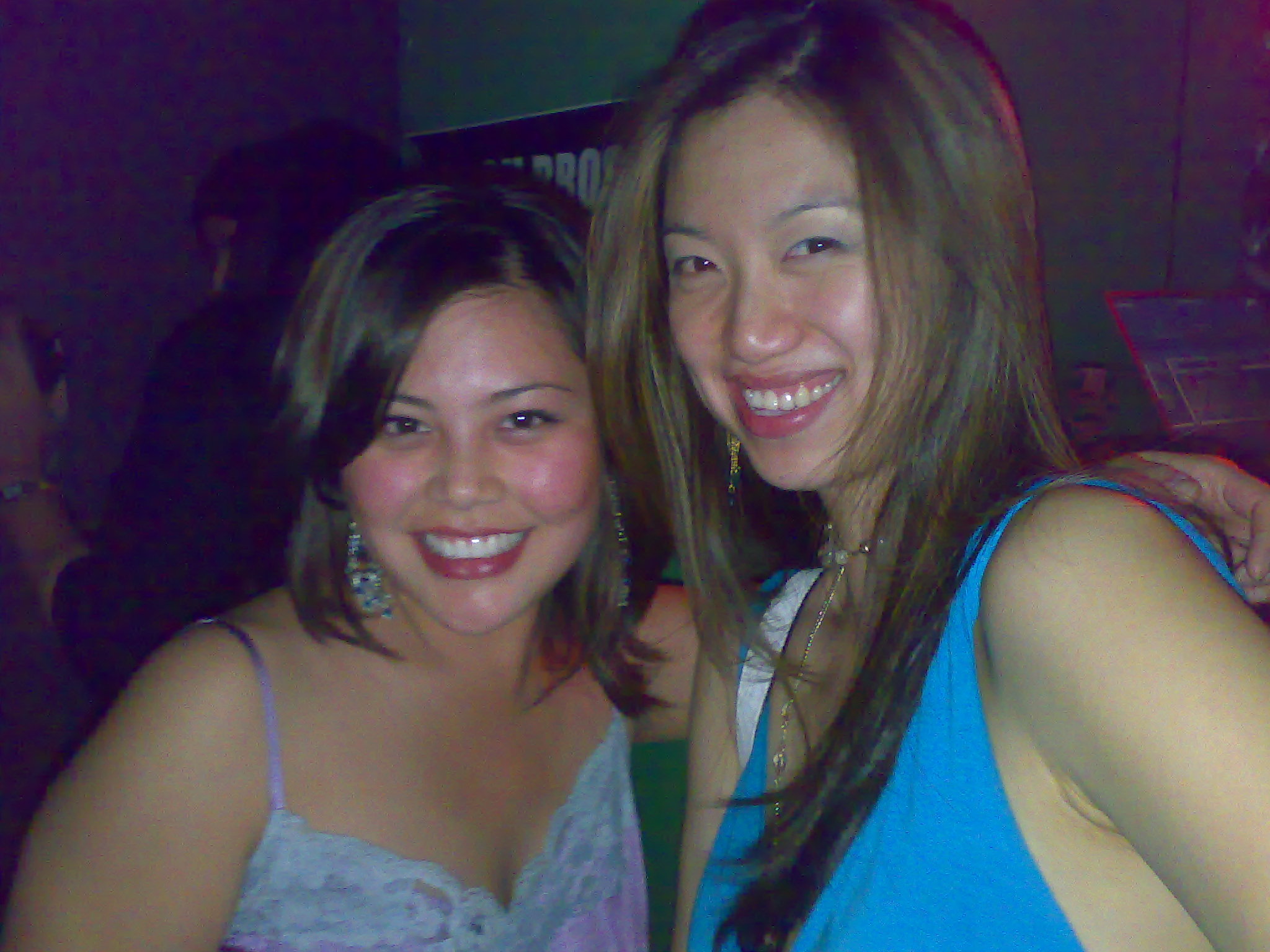 two young ladies posing for the camera at a party