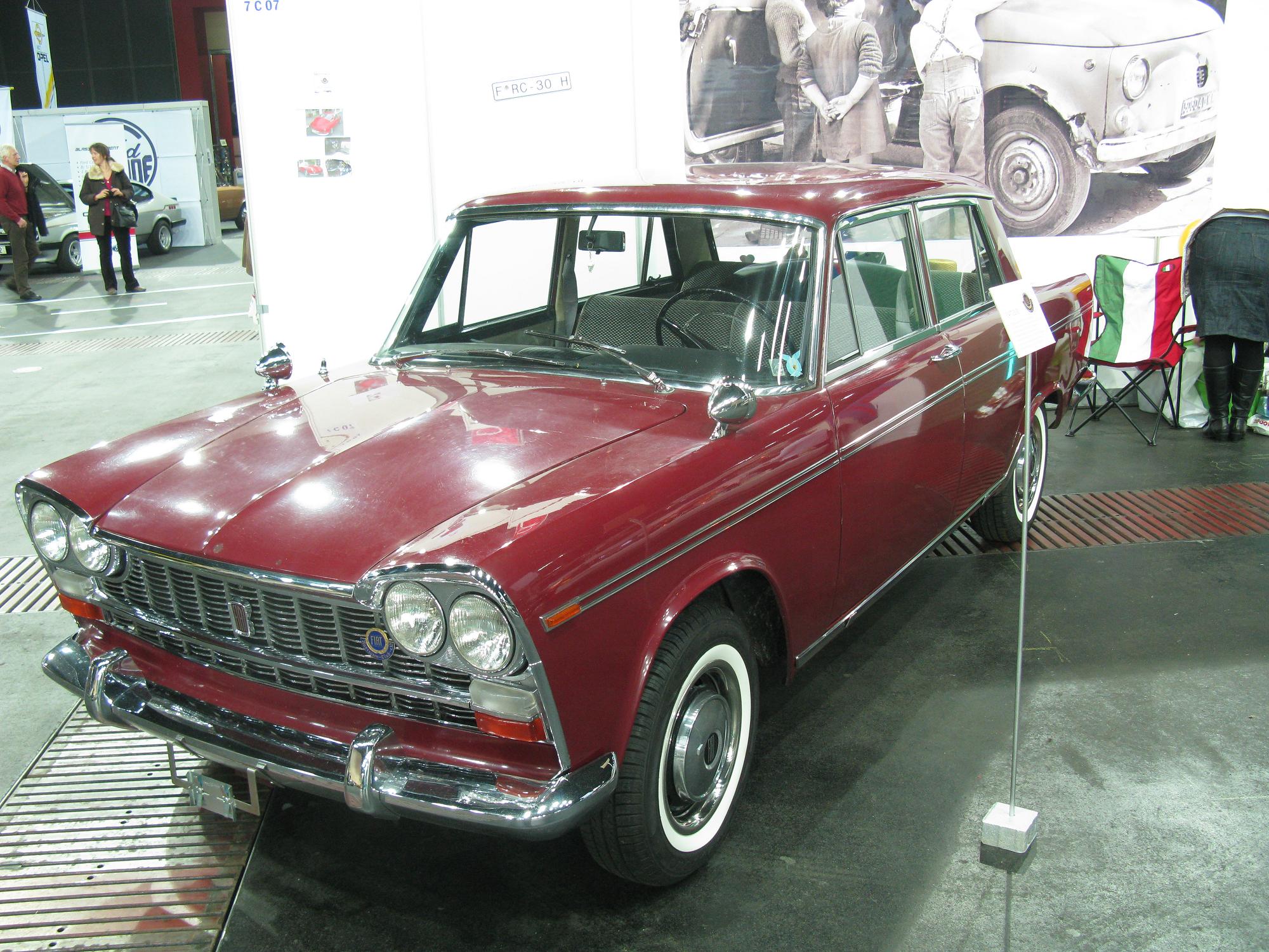 an old red station wagon is on display at a car show