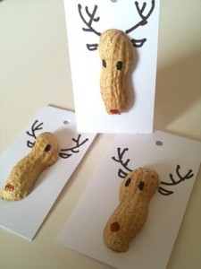 two brown pieces of food shaped like reindeer heads on a white card