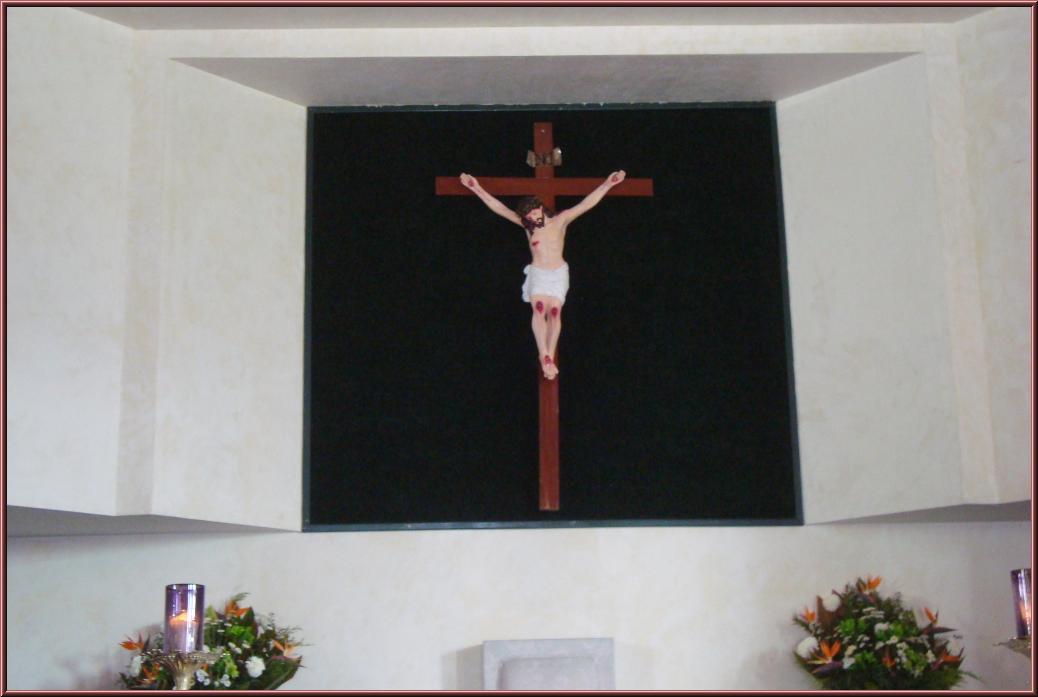 a religious cross in the corner of a room