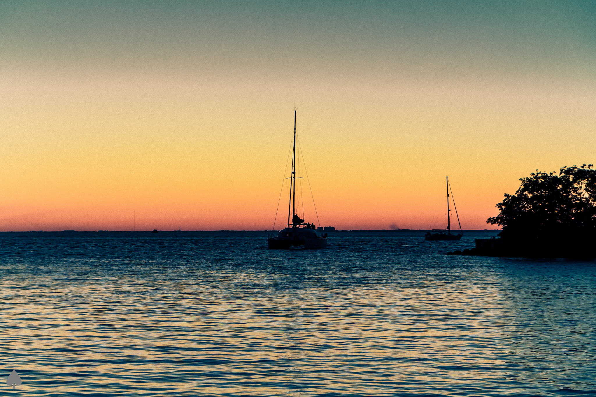 a small boat on a body of water at sunset