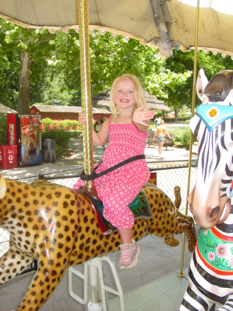 a  is riding a carousel on a fake ze