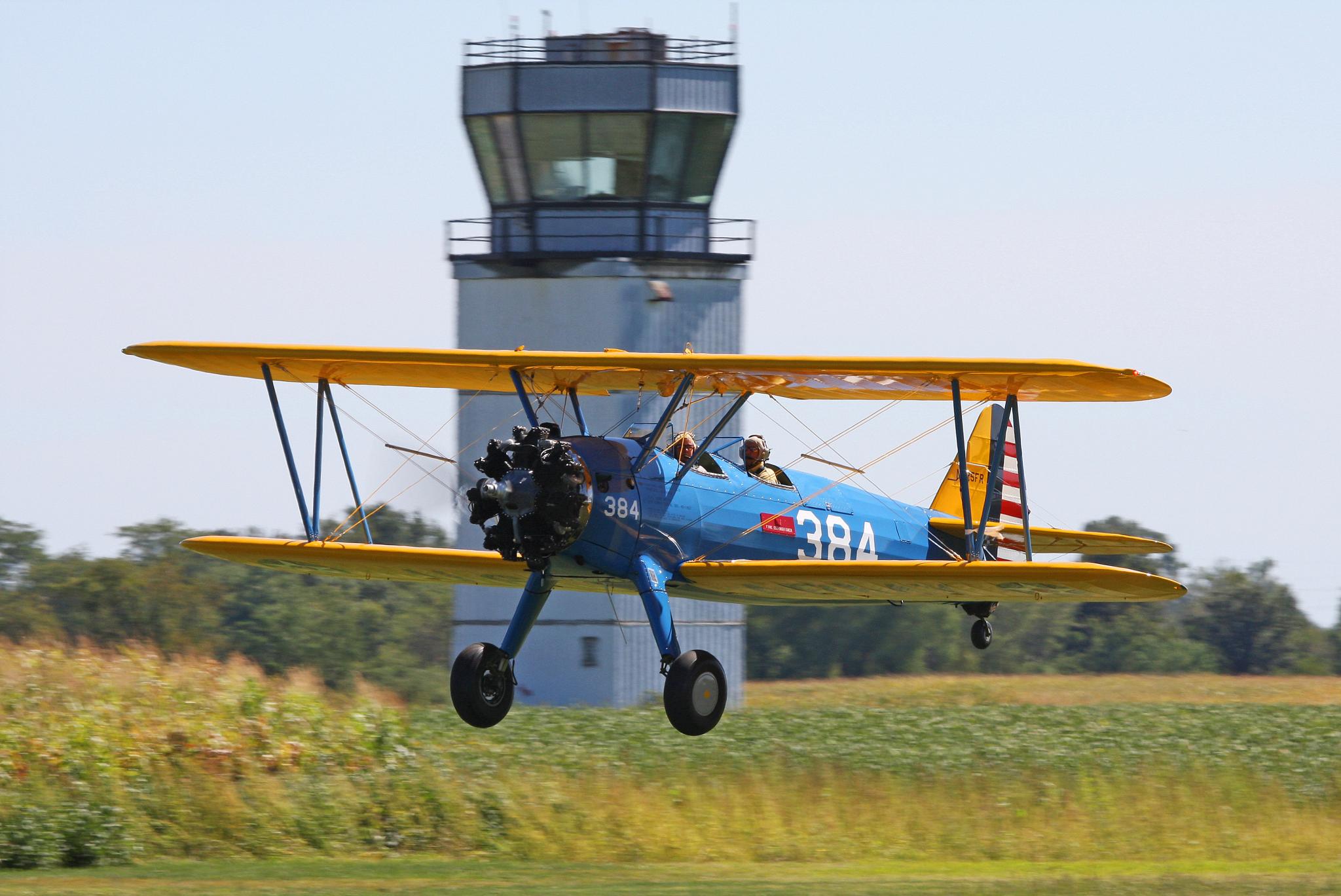 an old time plane in the middle of a field