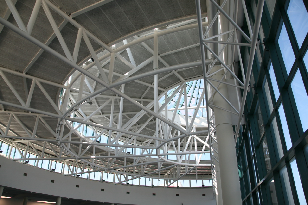 the inside of a building with a large circular metal structure above it