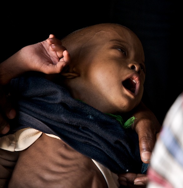 a baby has its head on his mother's shoulder