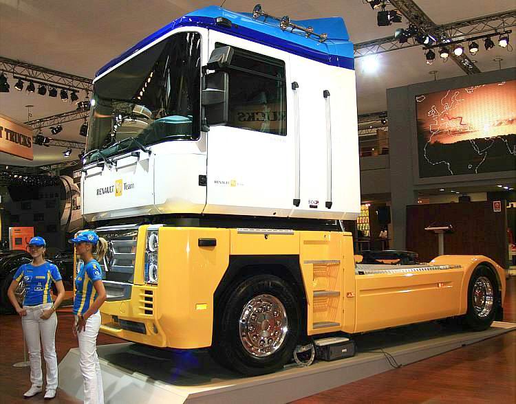 two people standing in front of a large truck