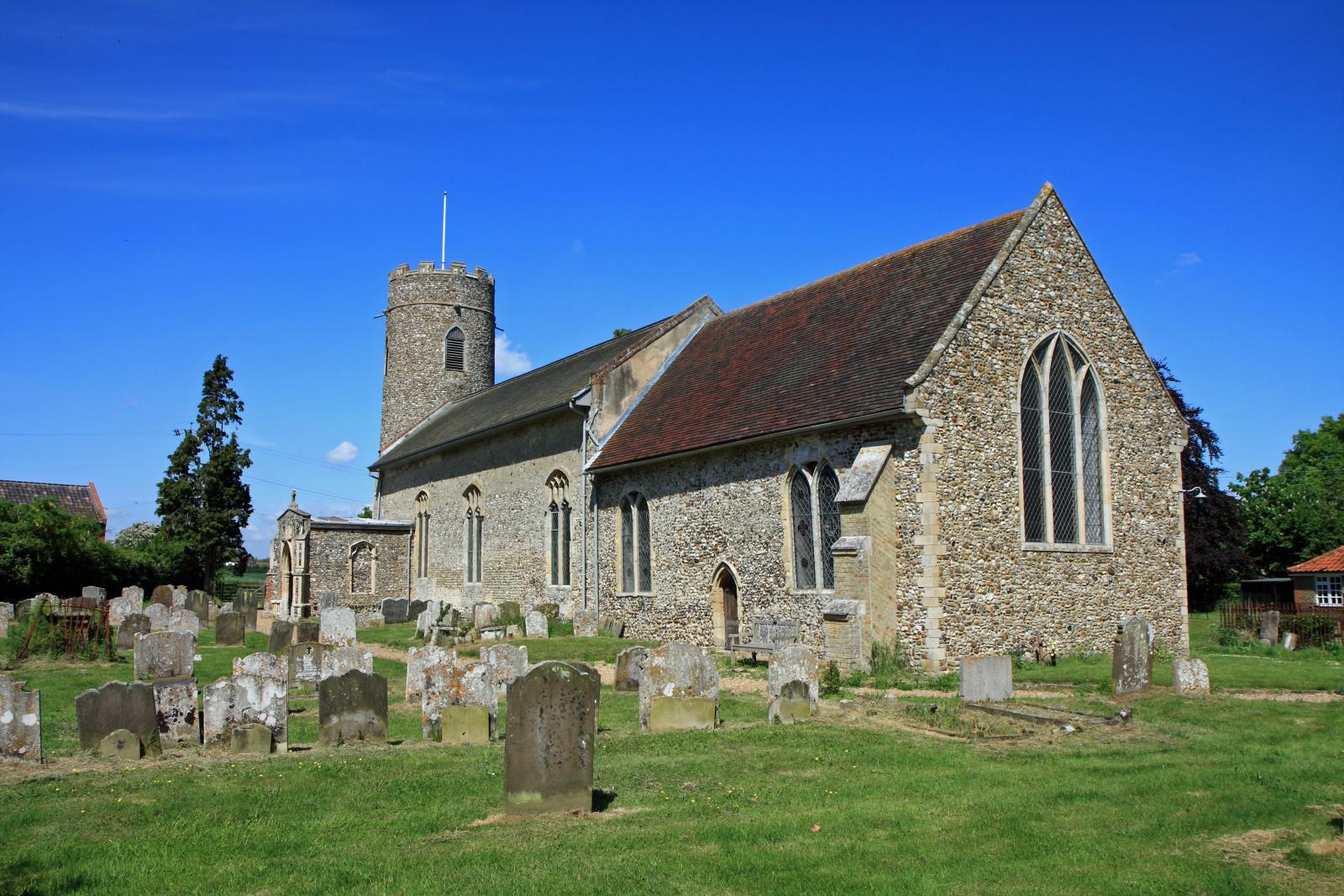 the stone building has many headstones and a tower