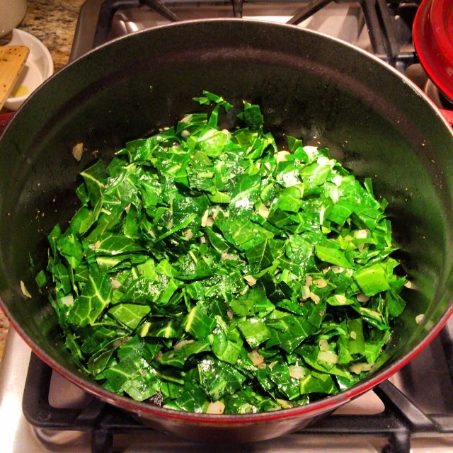 a pan full of vegetables is on a stove top