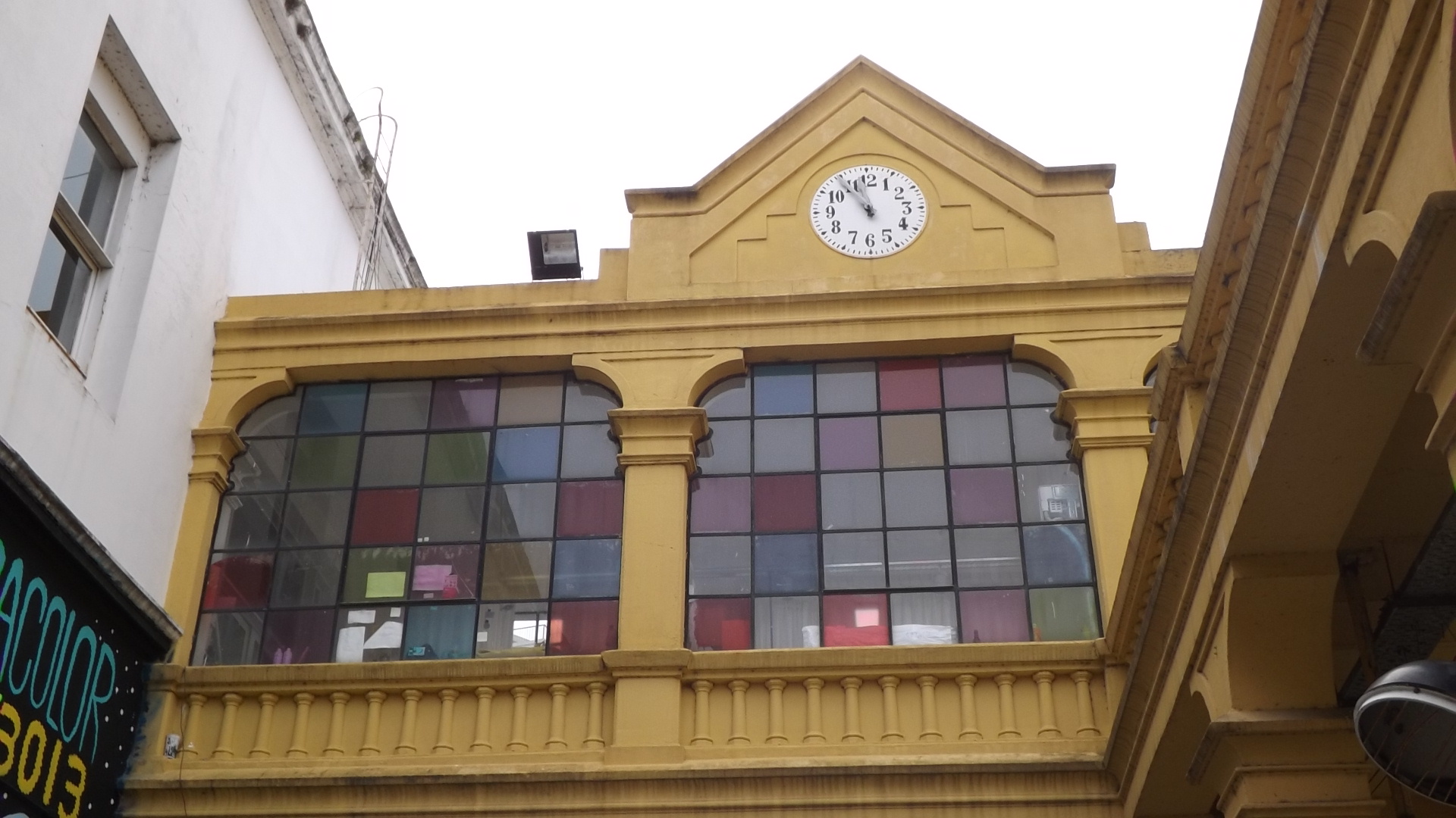 a yellow building with a large clock in the windows