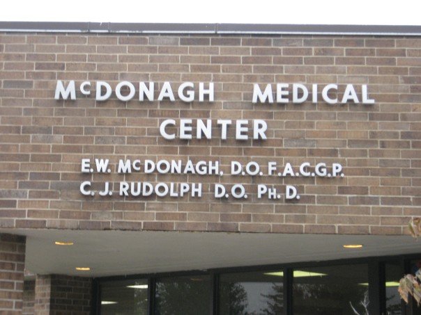 a tall brick building with the words moongah medical center written above the entrance