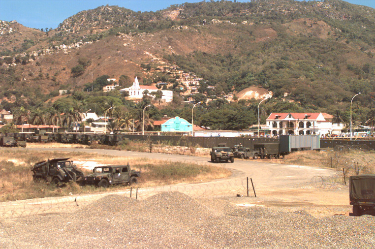 an old car park on the side of the road with some old vehicles