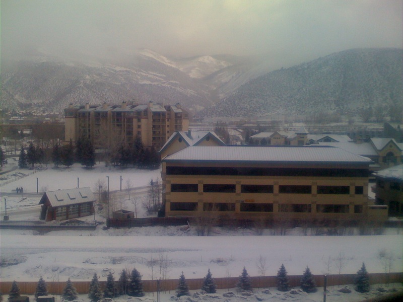 a snowy scene of two buildings next to each other