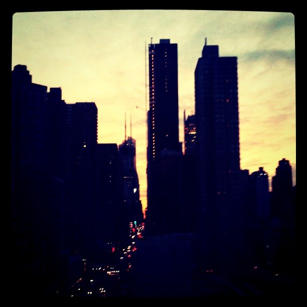 a picture of a city skyline with buildings, lights and sky in the background