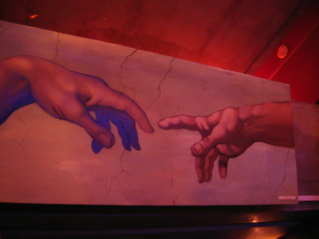 a mural with two hands touching each other