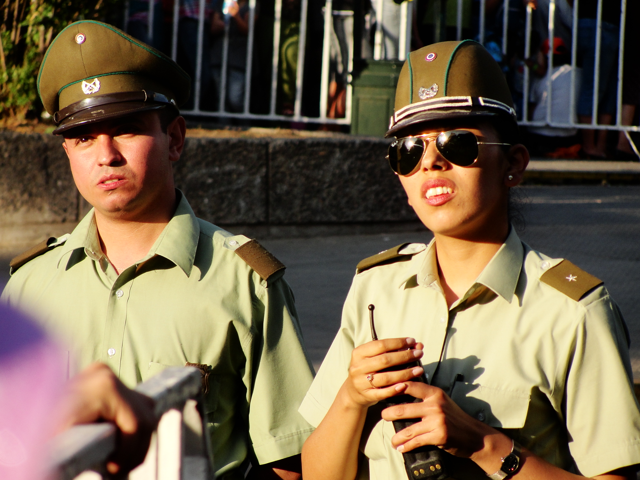 two people in uniform holding soing while looking at the camera
