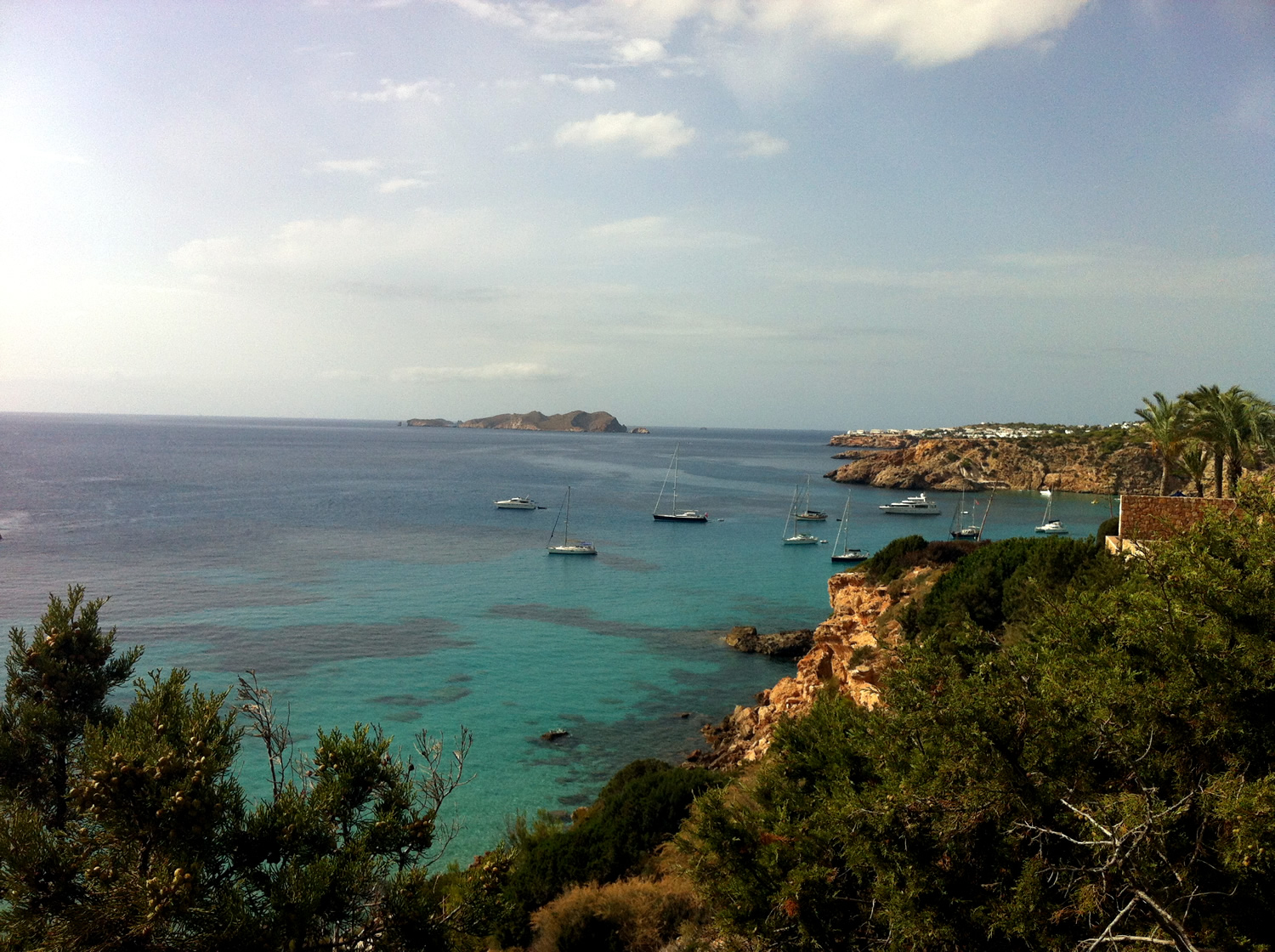 the boats are on the water near a shore