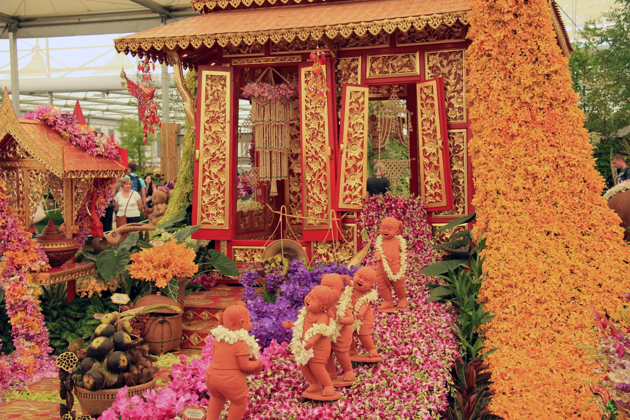 a flower festival with figurines in elaborate floral arrangements