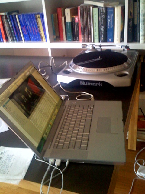 a laptop sitting in front of some books