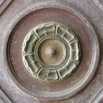 a circular metal object inside a drain in a bathroom