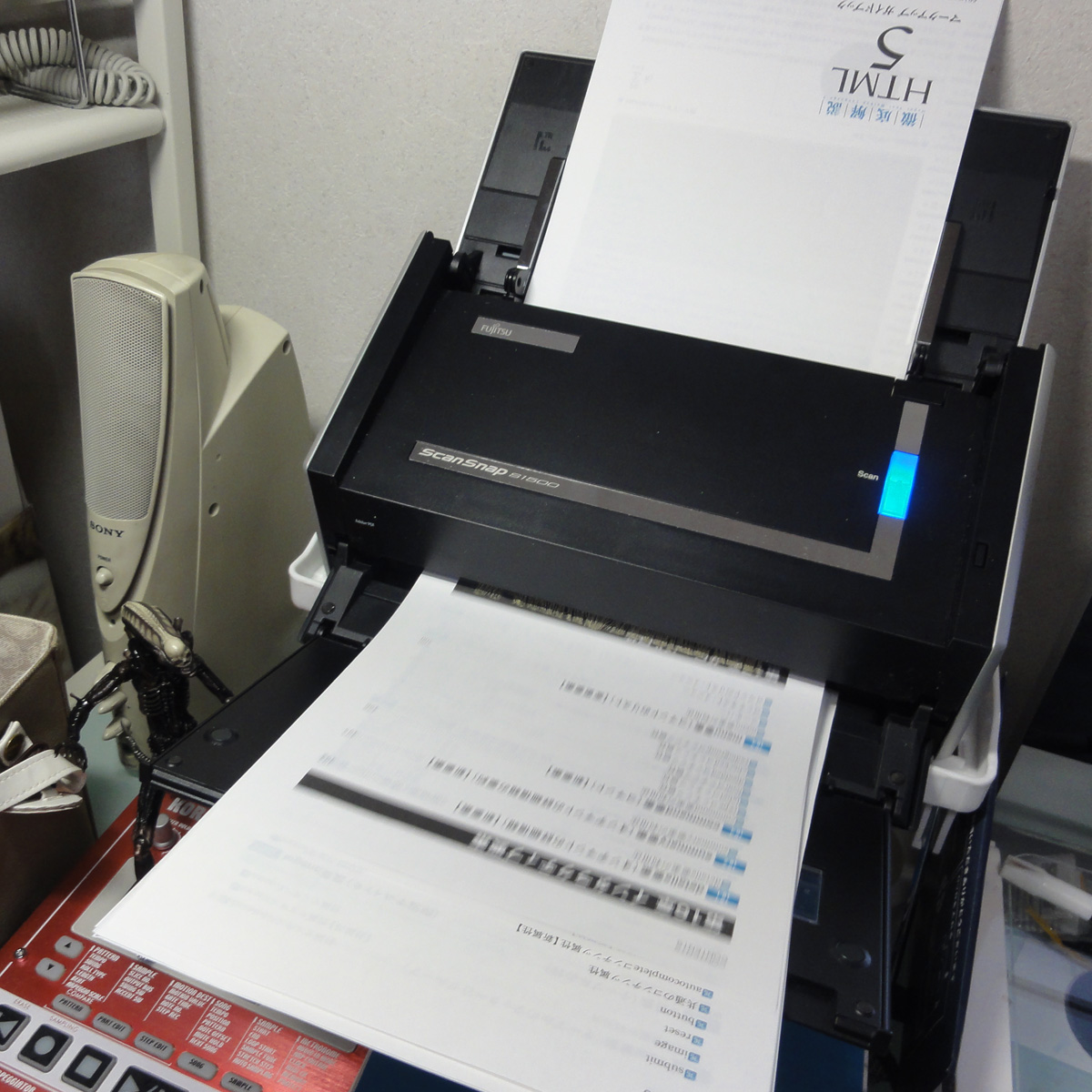 a sheet of paper is being pulled into a small printer