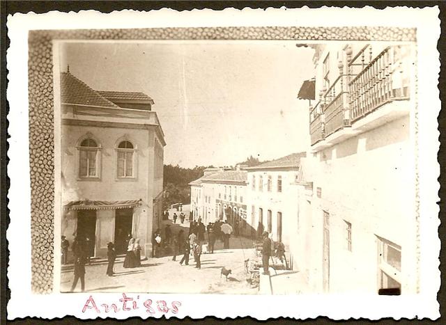 old black and white pograph of people walking down an alley