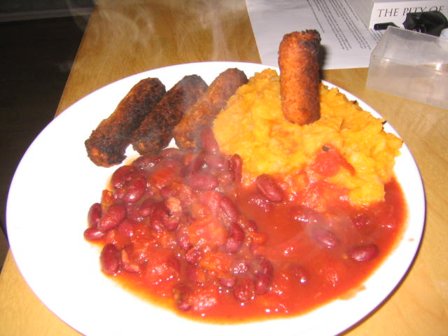 plate full of beans and sausage in red sauce